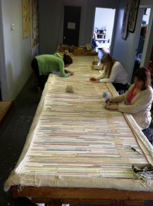 The girls have to make sure the colors are hooked in evenly through out the rug