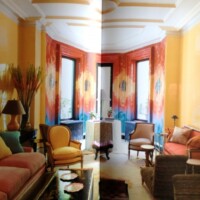 Vibrantly colored living room with eclectic decor and a bold orange-yellow color scheme.