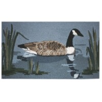A woven rug featuring a depiction of a Canadian goose in a water setting surrounded by reeds.