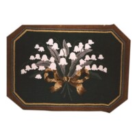 Octagonal rug with floral embroidery.