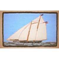 Sailboat with white sails on blue water depicted on a woven textile.