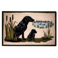 A doormat featuring an embroidered design of a black dog and puppy beside a pond with ducks.