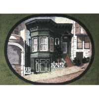 Embroidered depiction of a victorian-style house on a circular green background.