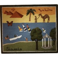 A colorful tapestry depicting various elements such as pyramids, palm trees, a camel, a sailing boat, butterflies, and a gazebo, with the word "sharm" woven at the bottom.