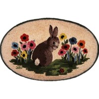 Oval rug with a needlepoint design of a brown rabbit among colorful flowers.