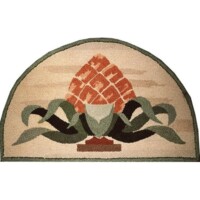 Semi-circular rug with a pineapple and leaf design.