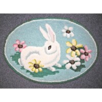 An oval rug featuring a white rabbit surrounded by flowers.