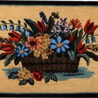 Embroidered floral arrangement on a textile surface with an octagonal border.