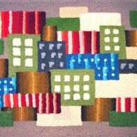 Colorful abstract textile design resembling a stylized cityscape.