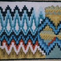 Handwoven textile featuring zigzag and geometric patterns.