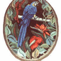 Embroidered patch depicting a blue parrot on a branch surrounded by foliage.