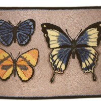Colorful embroidered butterflies on a textured fabric background.