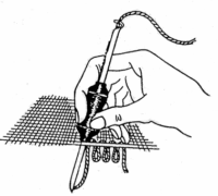 A hand using a needle to perform embroidery on a piece of fabric.