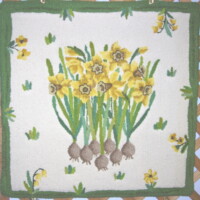 Handcrafted textile featuring a floral pattern with yellow flowers and green leaves.
