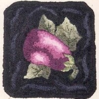 Embroidered purple turnip with green leaves on a dark background.