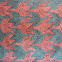 A patterned fabric with interlocking red and teal houndstooth motifs.