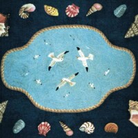 Ocean-themed textile pattern featuring seagulls over water surrounded by assorted shells on a dark background.