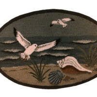 Embroidered patch depicting two white birds in flight over a beach scene with a seashell and vegetation.