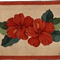 Octagonal floral needlepoint canvas with two red flowers and green leaves on a beige background, bordered with a terracotta outline.