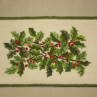 A rectangular mat with an embroidered holly design.