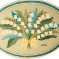 Oval vintage label with an illustration of a bouquet of lily of the valley.