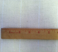 Ruler displaying measurements on a white textile surface.