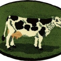 Hand hooked rug with a cow in the center