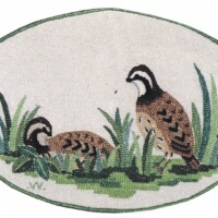 Embroidered patch featuring two quail among grass.