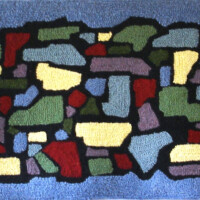 Abstract mosaic pattern rug with a variety of colored shapes on a blue background.