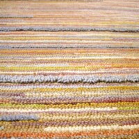 Close-up view of a striped textile with various colors.