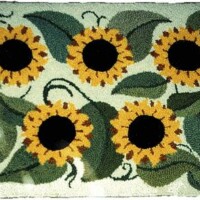 Floral rug with sunflower pattern and a bee design detail.