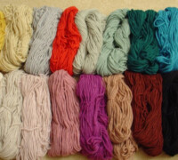 Assorted colorful yarn skeins arranged in a row.