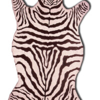 Zebra print rug in the shape of an animal hide.